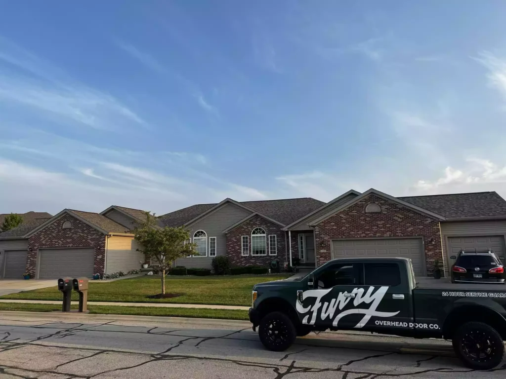 Furry truck in front of a garage door 